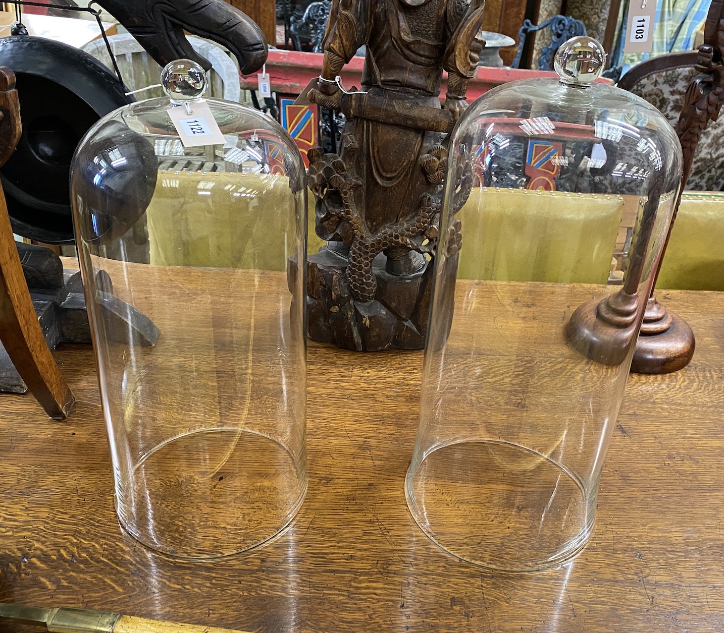 A near pair of glass domes, reputedly scientific instrument covers, larger height 54cm